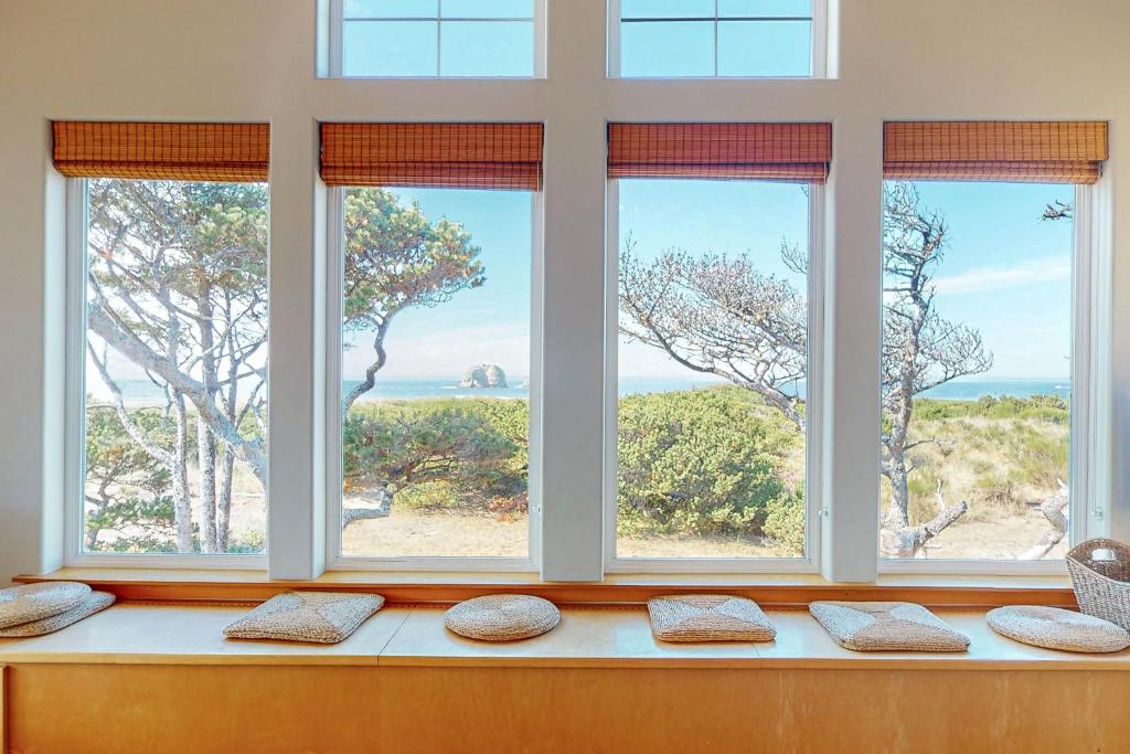 a window seat with four pillows in a room with a view at Twin Rocks Haven in Rockaway Beach