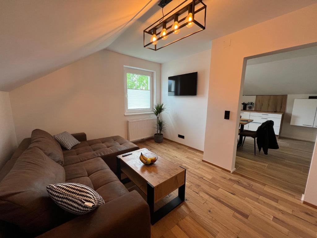 a living room with a couch and a table at Cityapartments Reutte-Mühl in Reutte