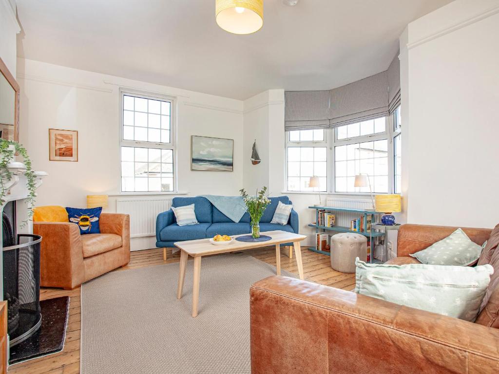 a living room with a couch and a table at The Old Toll House in Teignmouth