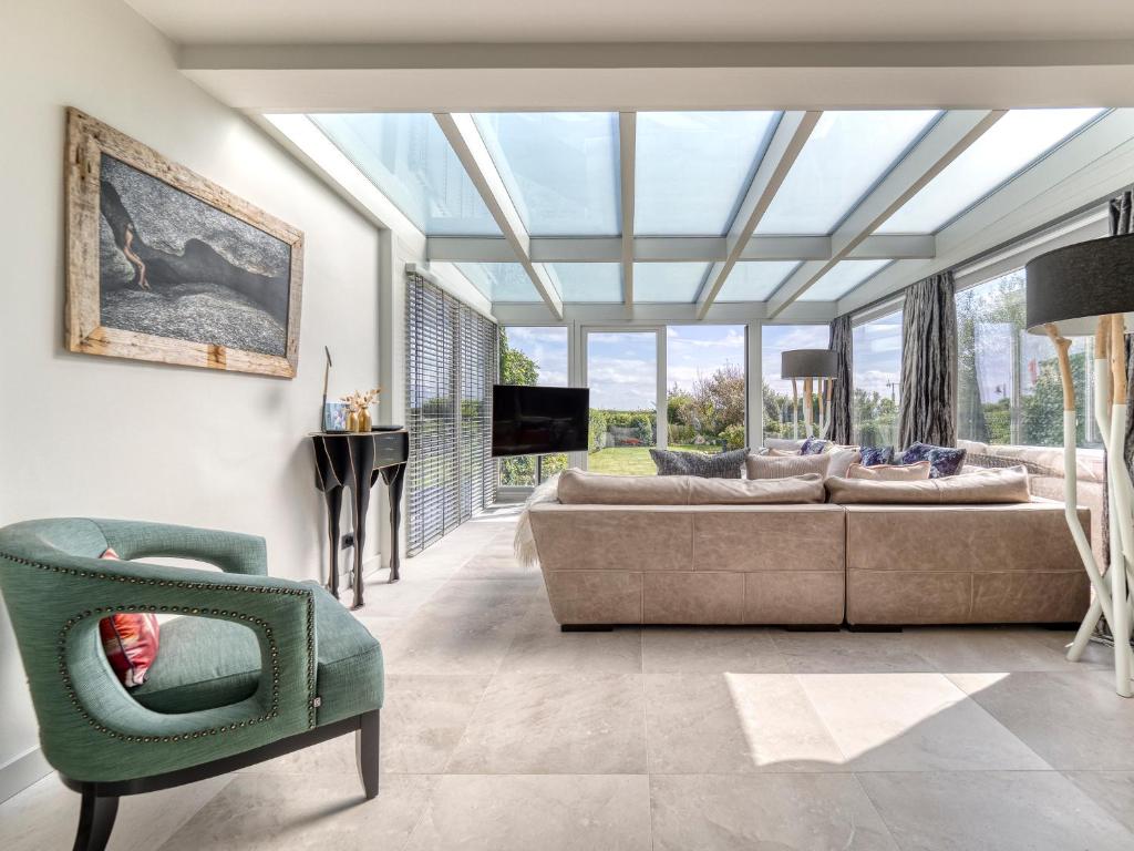 a living room with a couch and a chair at Haus Watt`n Blick in List