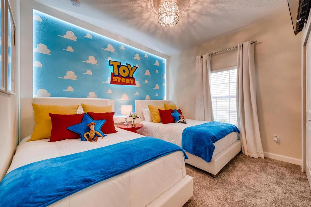 two beds in a bedroom with a toy story sign on the wall at 4825 LL - Storey Lake in Kissimmee