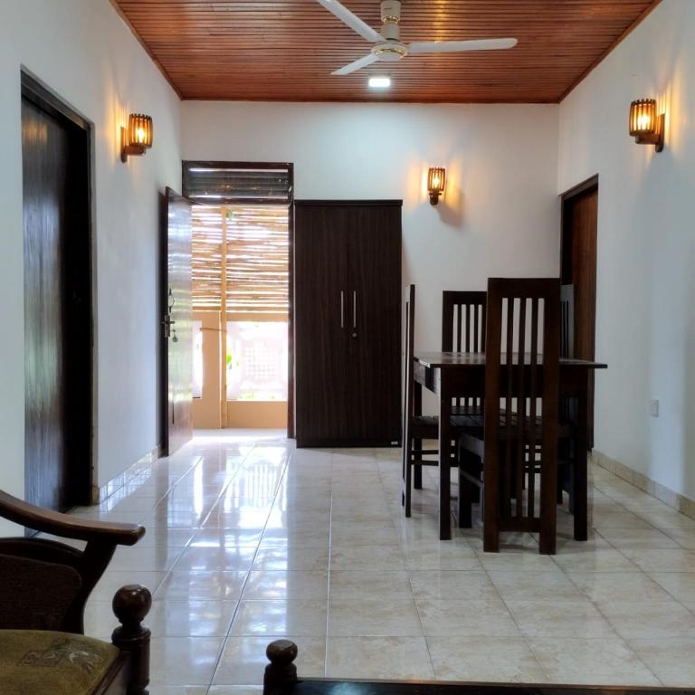 a dining room with a table and chairs and a ceiling at Villa Aroma Ahangama in Ahangama