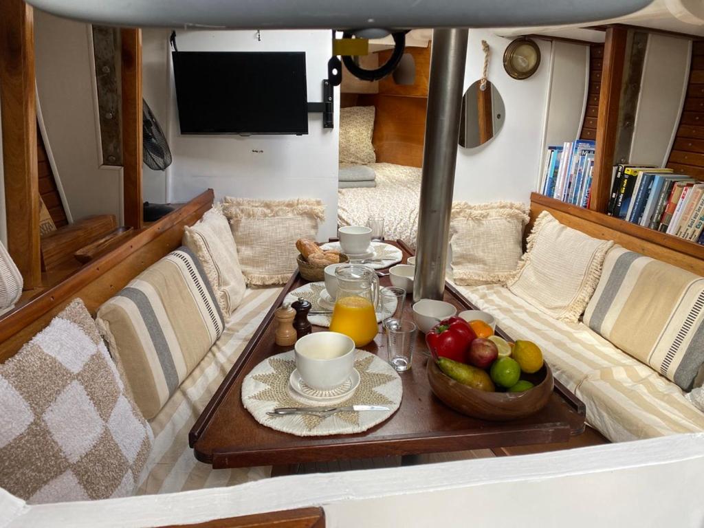 a table with a bowl of fruit on a boat at Séjour insolite à bord d'un voilier de 11m - Charmante Marina proche Barcelone in Sitges