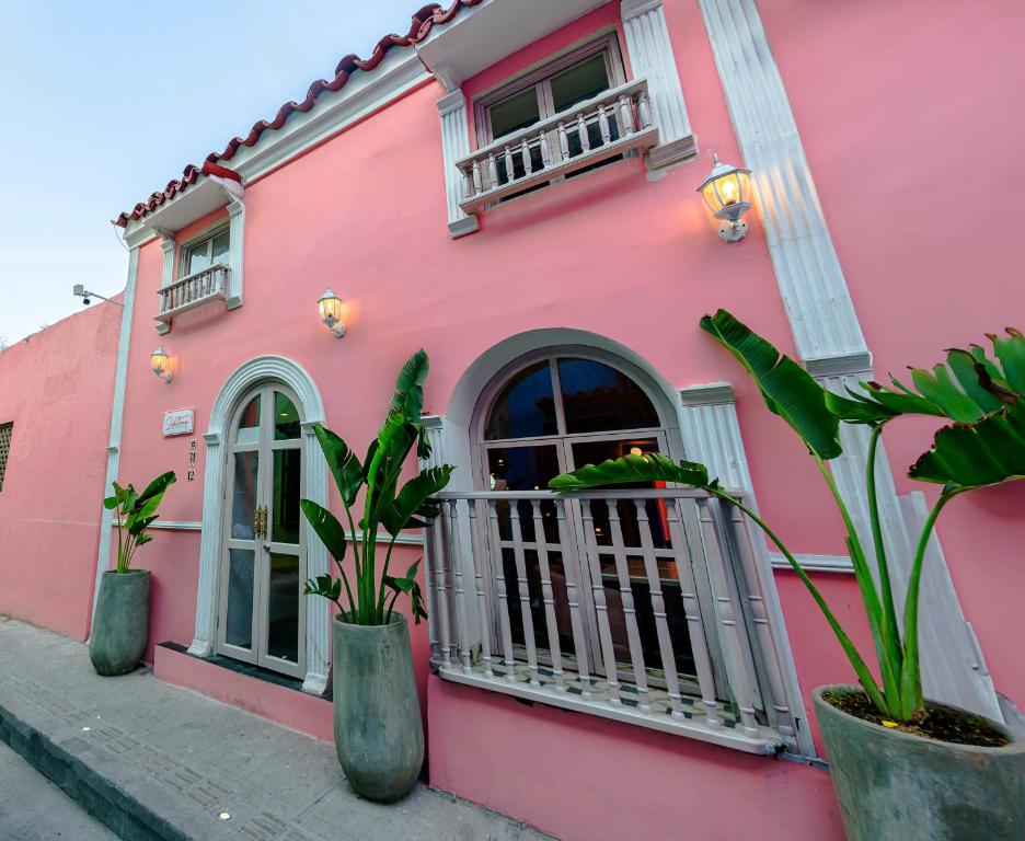 a pink building with plants in front of it at Sublime Hotel Cartagena in Cartagena de Indias