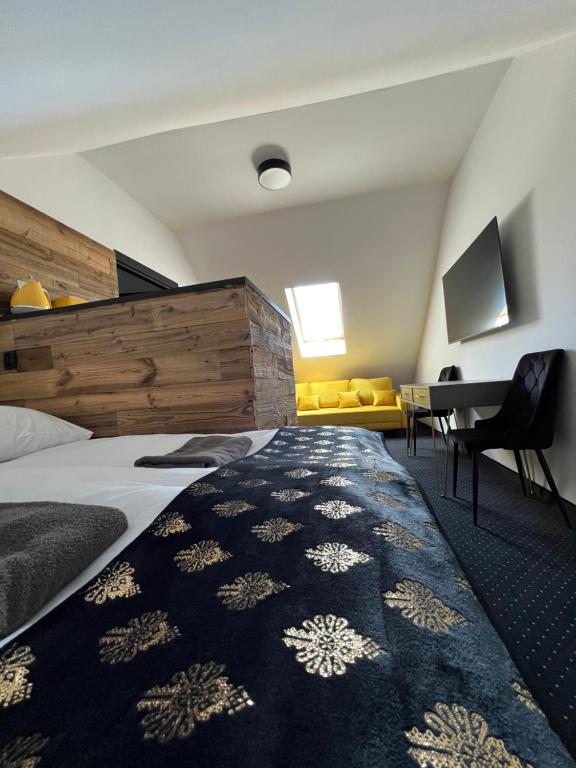 a hotel room with a bed and a desk at Willa przy Krupówkach in Zakopane