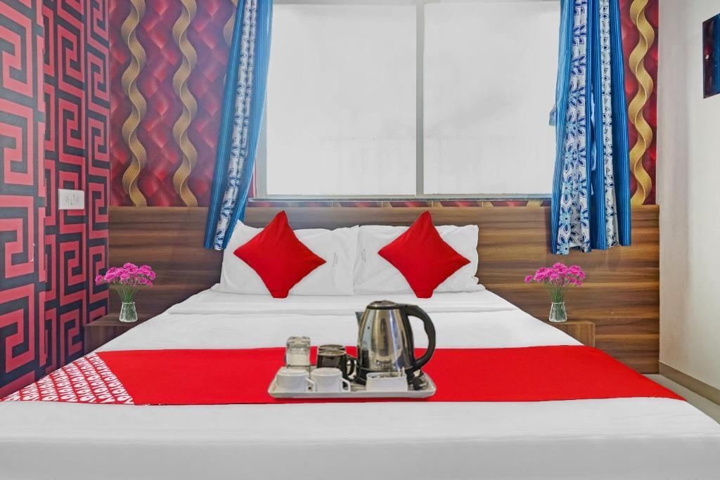 a hotel room with a bed with a blender on it at SPOT ON Swarg Executive Paradise Near Fun Time Multiplex in Māngvādi