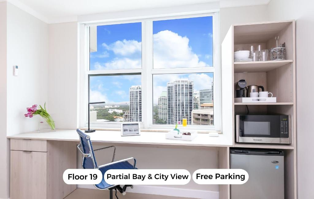 a window with a view of a city from a desk at MVR Not a normal suite-An Elevated Miami Stay in Miami
