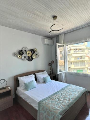 a bedroom with a bed and a window at Aqua Mare Luxury Lodgings in Amfilochía