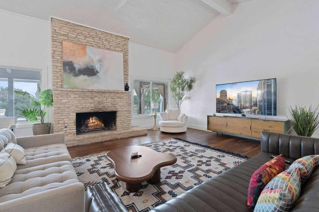a living room with a couch and a fireplace at Luxurious Modern Retreat with Private Pool & Patio in Austin