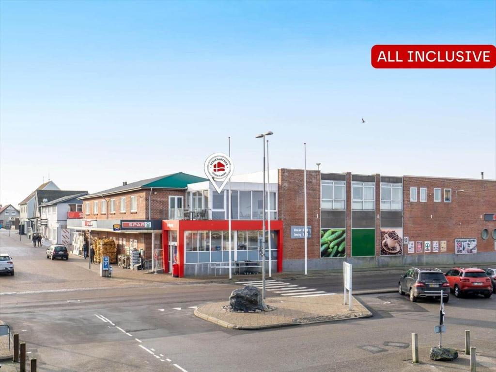 an empty parking lot in front of a building at 804-Hvide-Sande-Havnegade-2-1-A in Hvide Sande