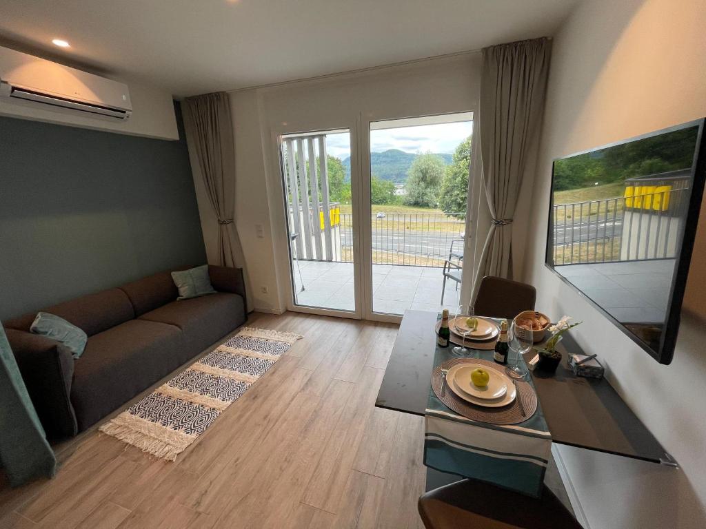 a living room with a couch and a table at Stunning Wörthersee Holiday Home 16 in Sekull
