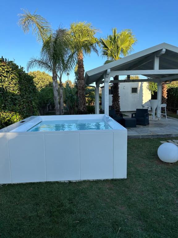 a swimming pool in a yard with a pergola at Apulian Sea House in Scogli di Apani