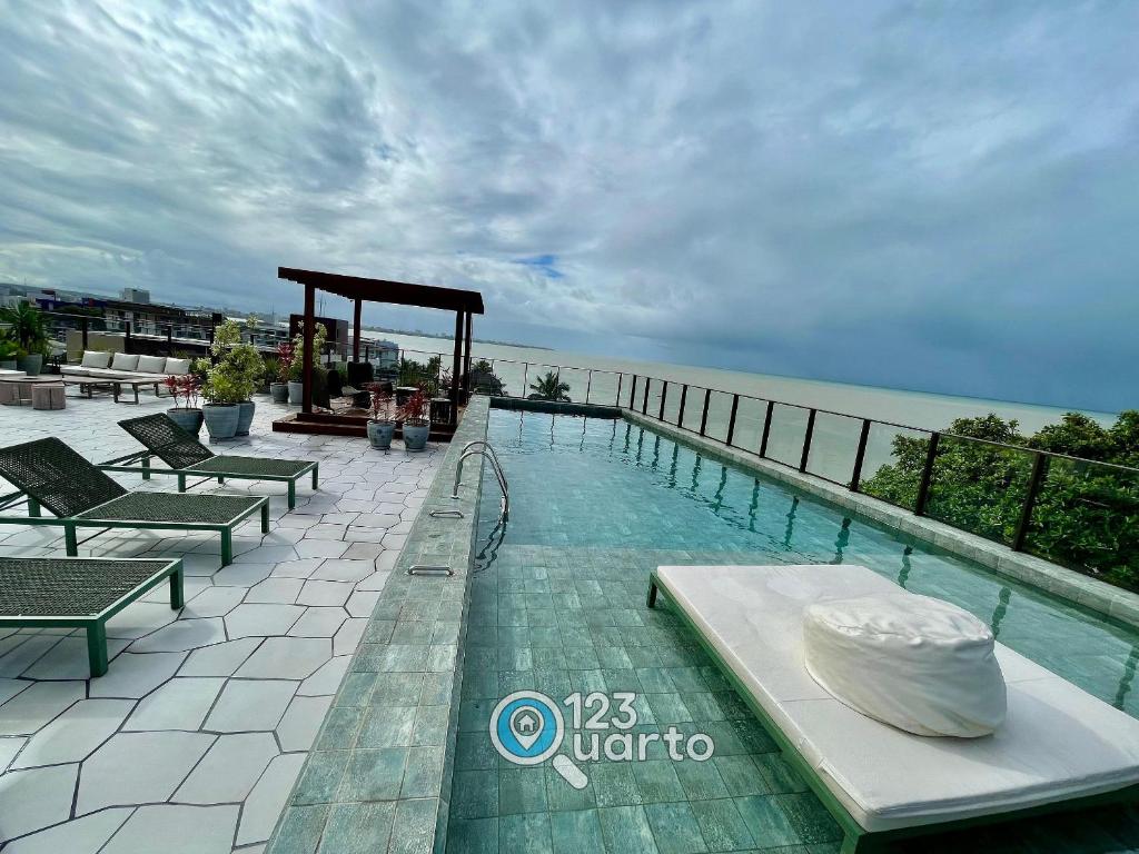 a swimming pool with a gazebo next to the water at Get Sense By 123Quarto Hospedagem in Tambaú