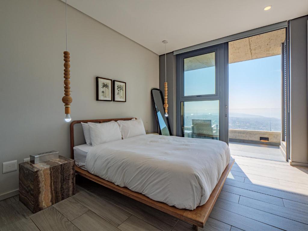 a bedroom with a large bed and a large window at Umhlanga Arch - Ocean Views, Queen size bed plus free wifi in Durban