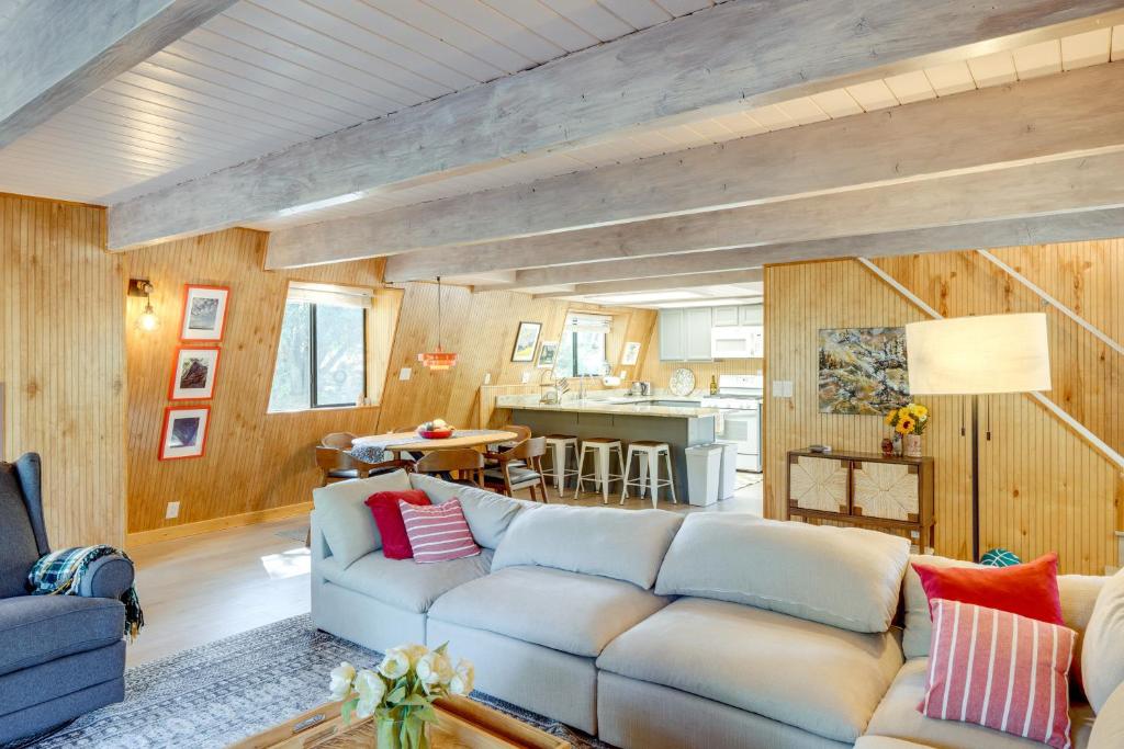 a living room with a couch and a kitchen at Walk to Village Cozy Cabin in Pine Mountain Club! in Pine Mountain Club