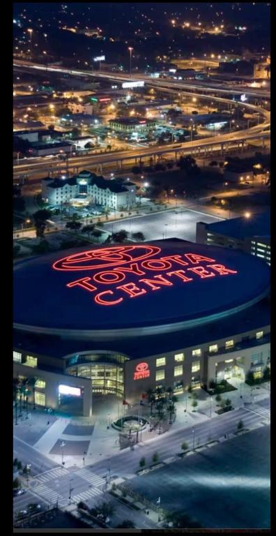 a large building with a large red sign on it at night at Distinct Houston Luxury Downtown in Houston