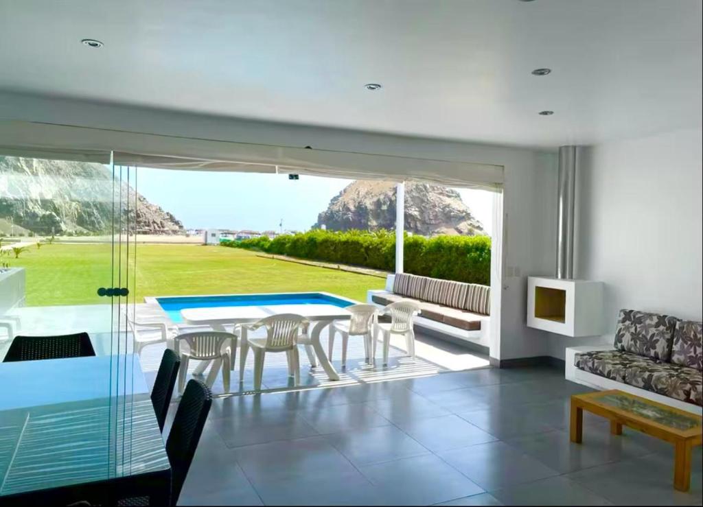 a living room with a table and chairs at Casa de Playa frente al mar en Chocalla, Asia in Asia