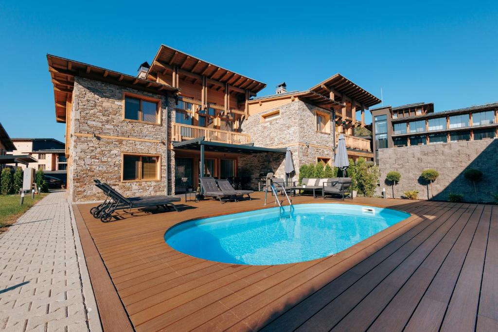 a house with a swimming pool on a wooden deck at Aqua Thermal Villa Banya in Banya