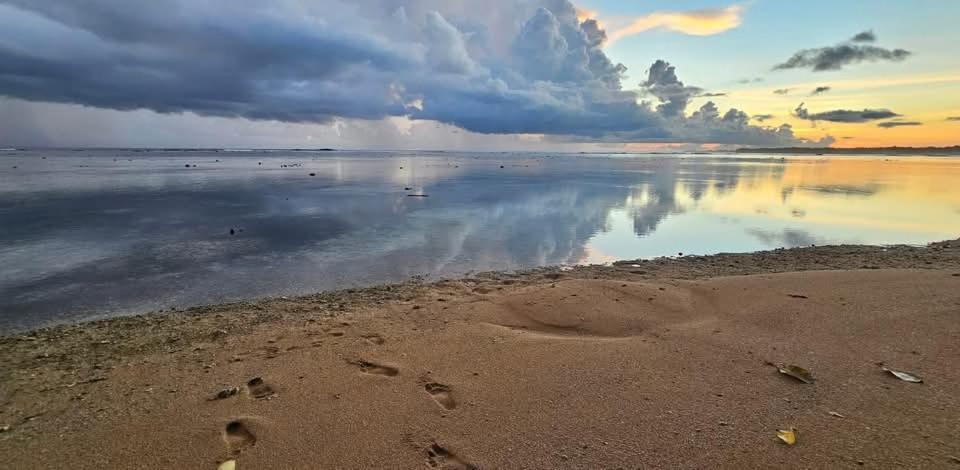 a group of footprints in the sand on the beach at Wane's BnB in Nadi
