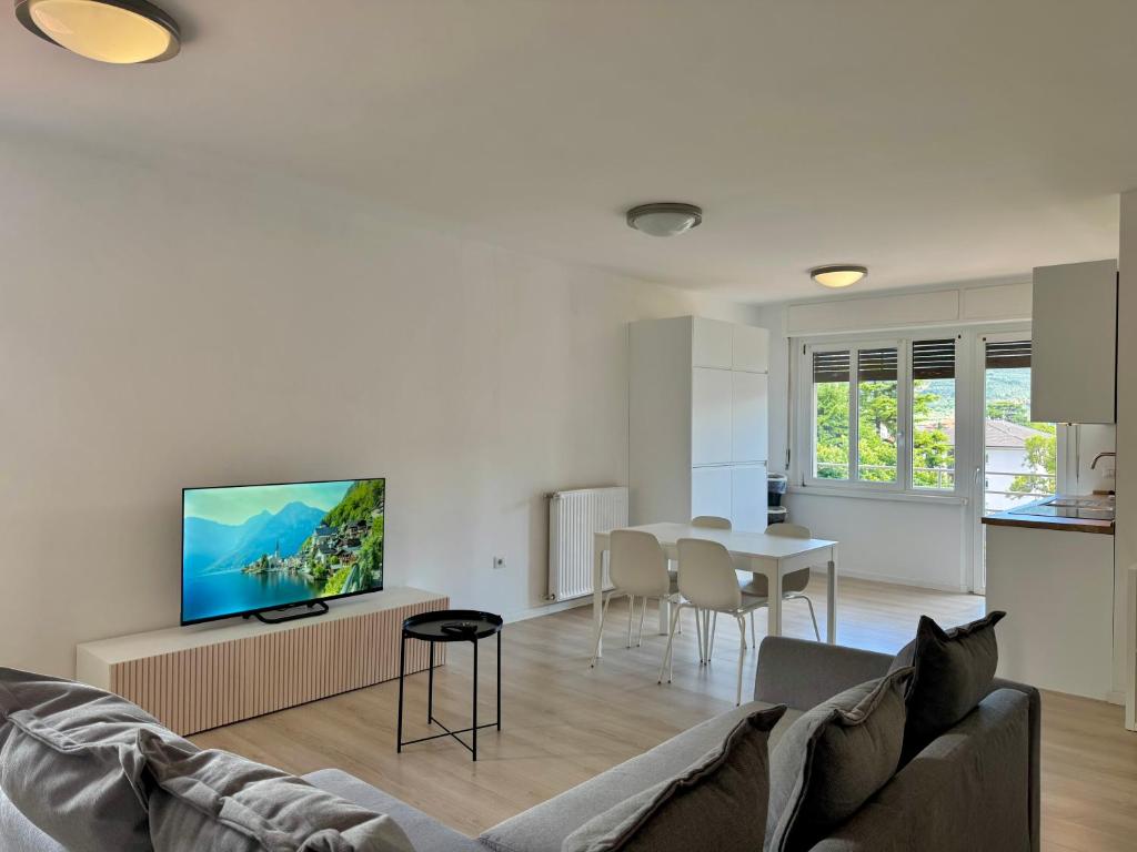 a living room with a couch and a table at 1Dest - The Roman Spot in Riva del Garda