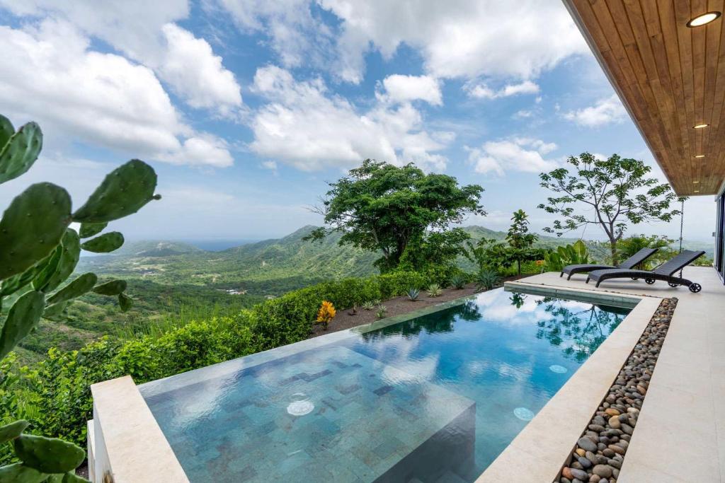 View of Mountainside Home with Modern Design Sweeping Ocean Views & Private ...