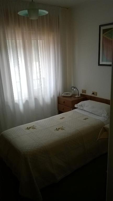 Postel nebo postele na pokoji v ubytování Albergo Ristorante Iris