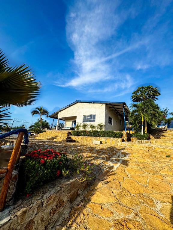 a white house on a hill with a tree at Liz&Mar in El Morro