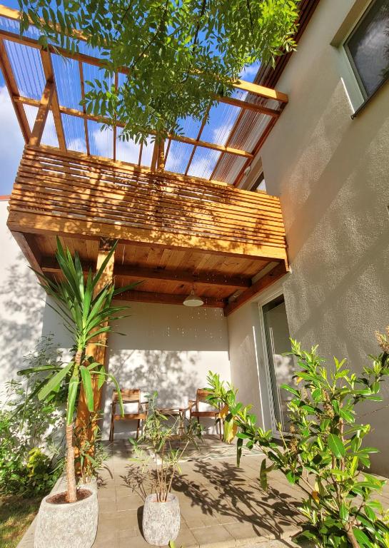 a patio with chairs and awning with a roof at Apartamenty Ponidzie in Busko-Zdrój