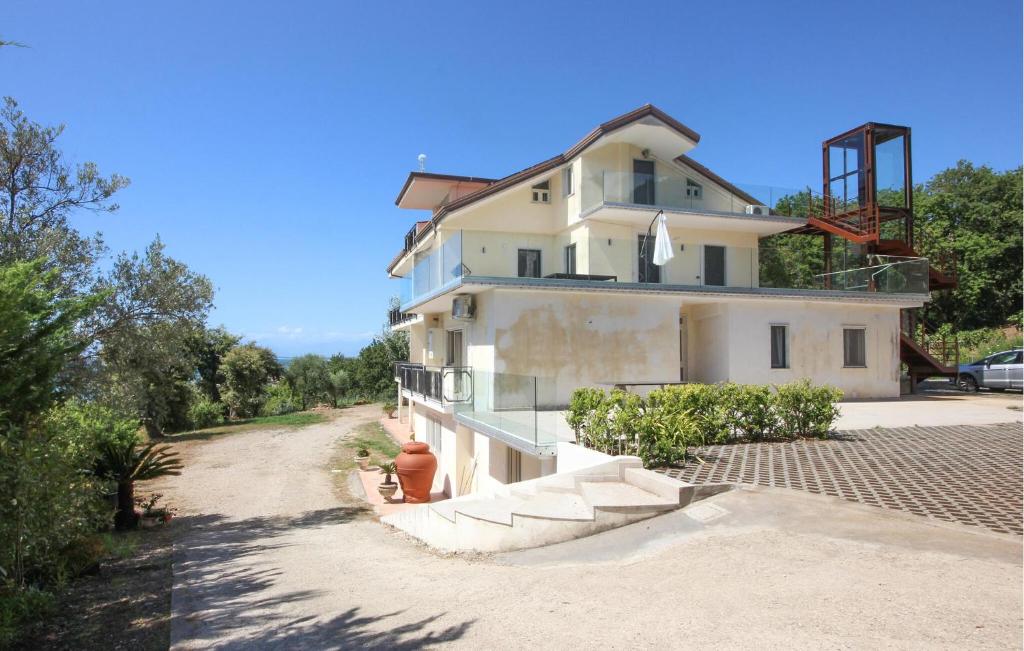 a large white house on a dirt road at Stunning Apartment In Agropoli in Agropoli