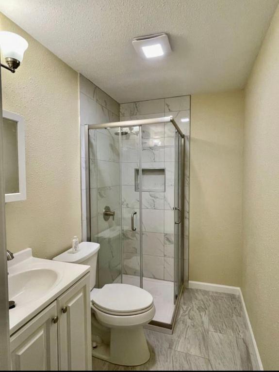 a bathroom with a shower and a toilet and a sink at Private Room "Cherry" by UW in Seattle