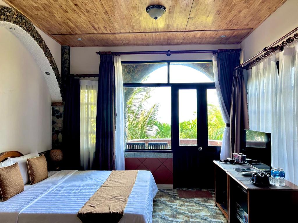 Giường trong phòng chung tại Sầm Sơn Boutique Hotel Phan Thiết