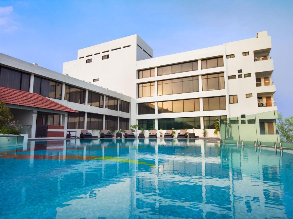 a swimming pool in front of a building at The Sunway Manor in Puducherry