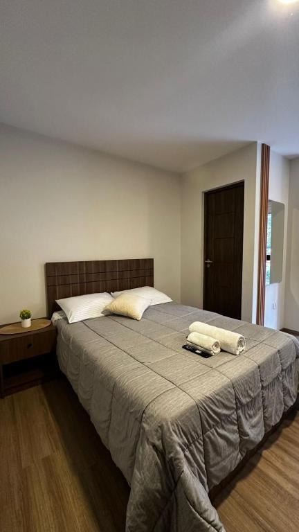 a bedroom with a large bed with two towels on it at Lovely studio apartment in Cochabamba