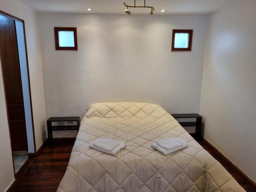 a bed in a room with two towels on it at Paseo de la Fe in Salta