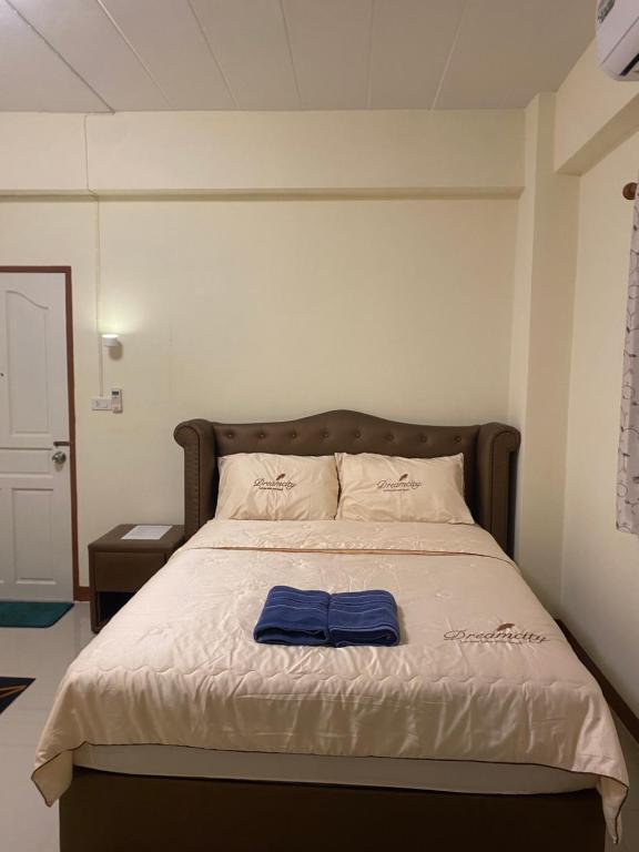 a bedroom with a bed with a blue towel on it at Boontorsub in Ban Khlong Samrong