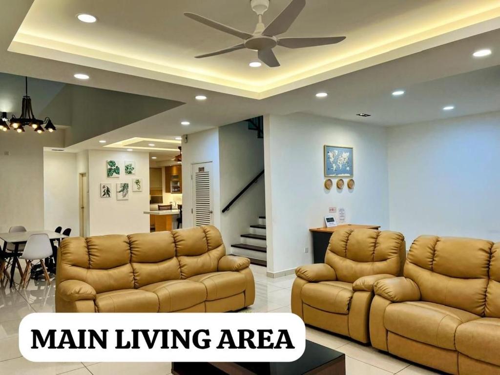 a living room with two couches and a ceiling fan at Alur Homestay Villa 4 Bedrooms in Lahad Datu