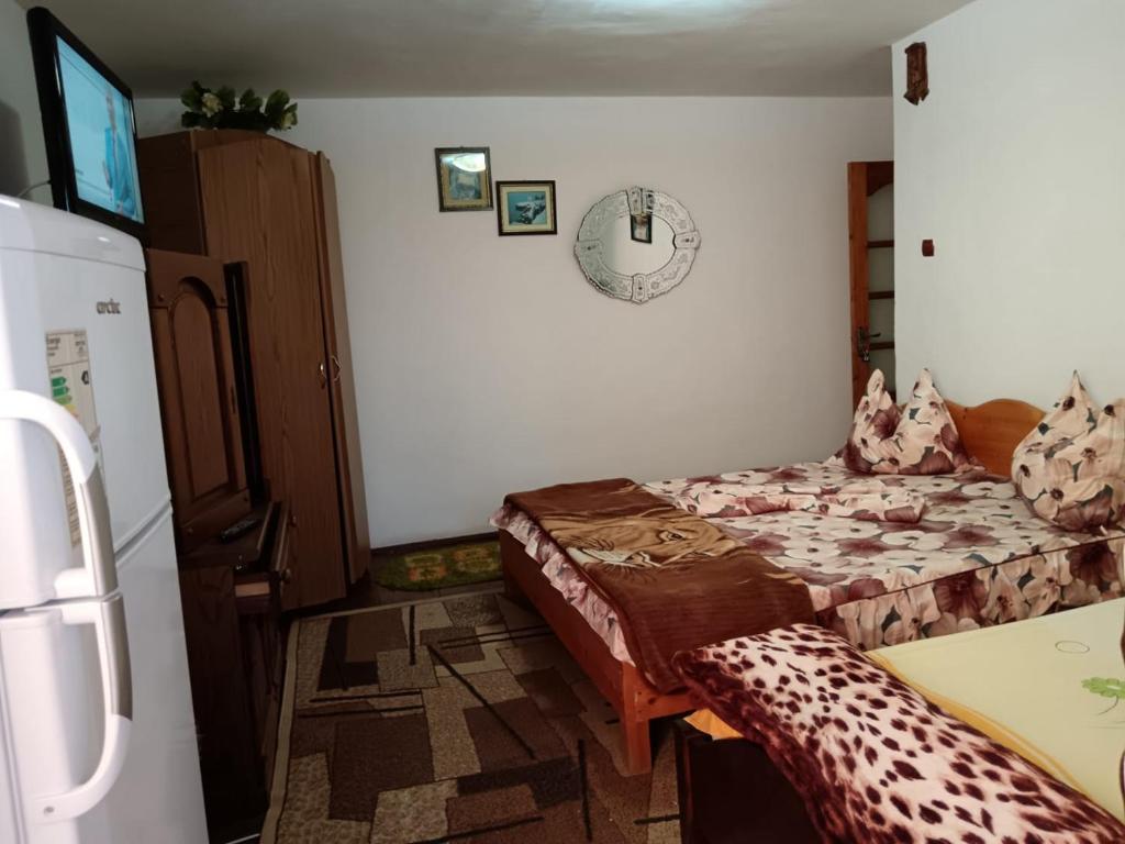 una habitación con una cama y una nevera en Tarra Garsoniera10, en Mangalia