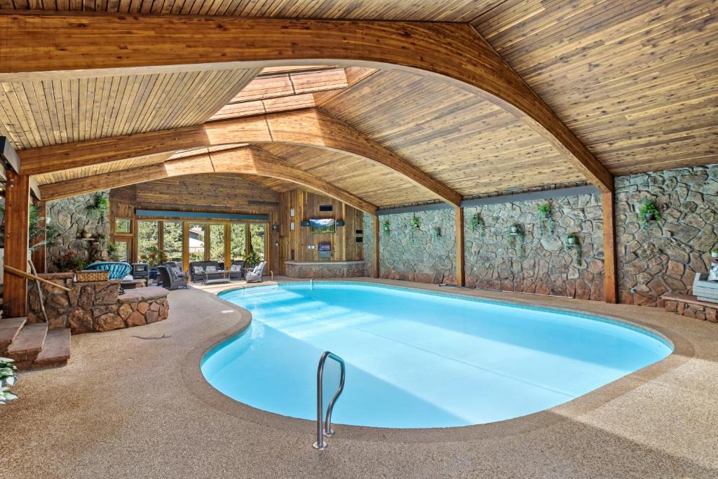an indoor pool in a house with a wooden ceiling at Panorama Vacation Home by Estes Park Homes home in Estes Park