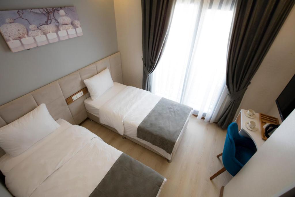 Postel nebo postele na pokoji v ubytování Royal İnci Hotel