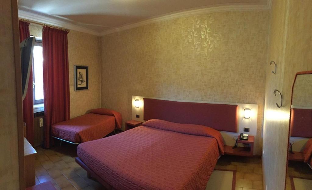 Postel nebo postele na pokoji v ubytování Euro Hotel