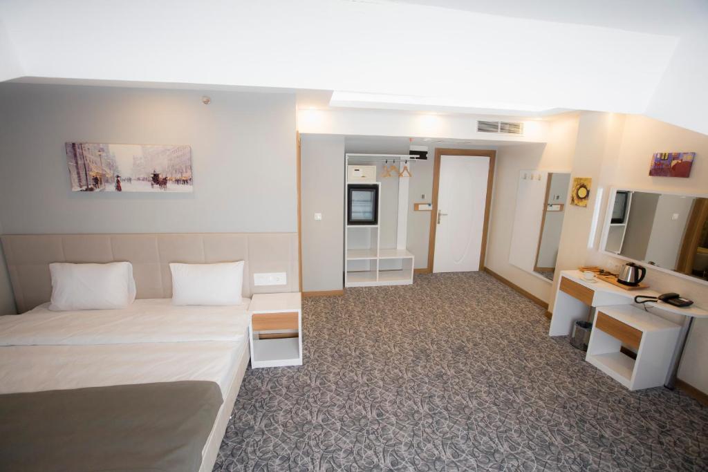 Postel nebo postele na pokoji v ubytování Royal İnci Hotel