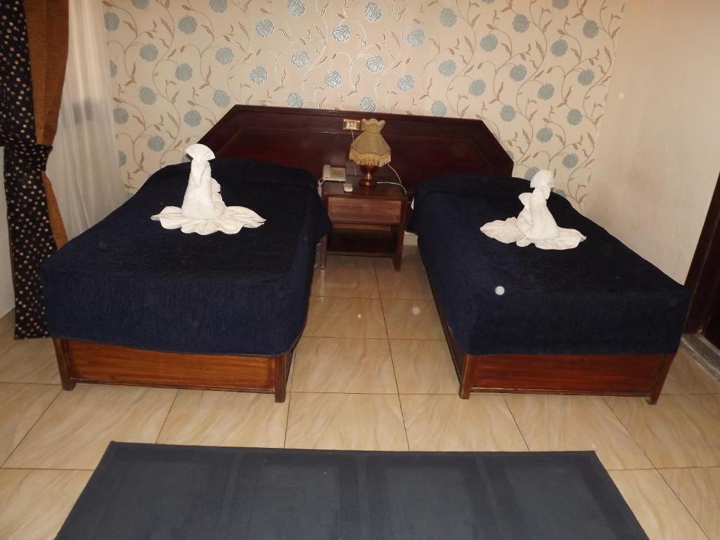 Postel nebo postele na pokoji v ubytování Mayorca Hotel Cairo