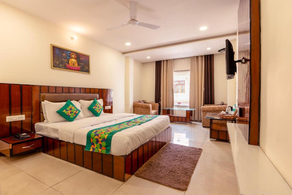a hotel room with a bed and a television at Treebo Red Coral in Haridwār