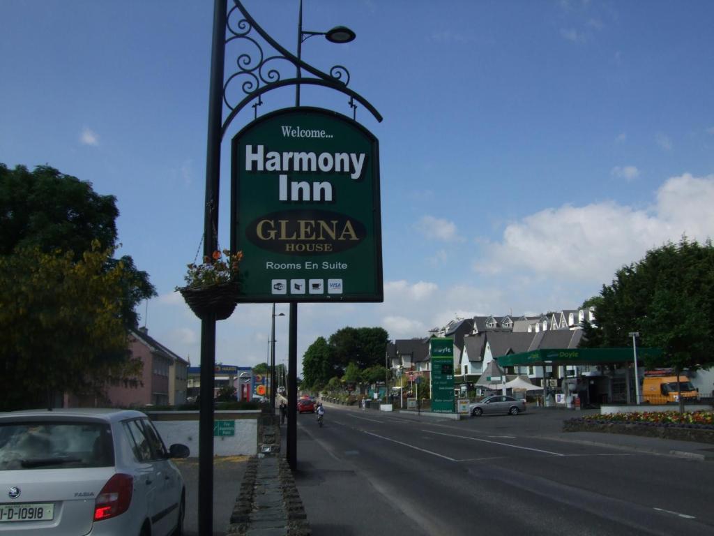 a sign for a hambury inn on the side of a road at Harmony Inn - Glena House in Killarney