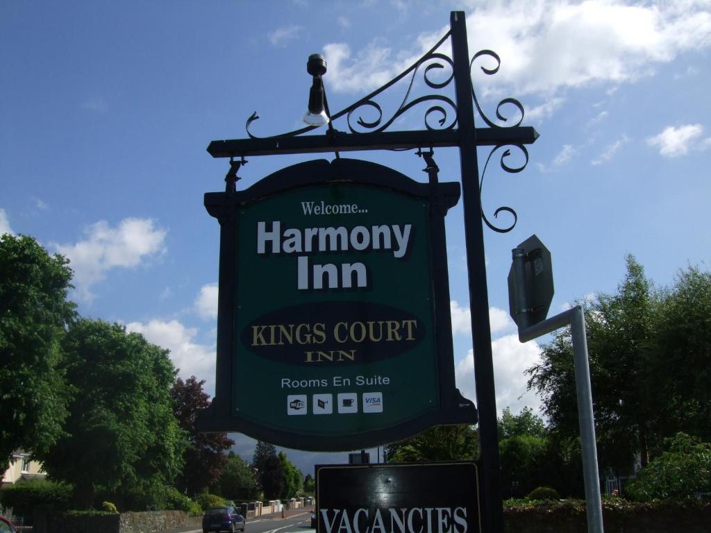 a sign for a kings court inn on a street at Harmony Inn - Kingscourt in Killarney