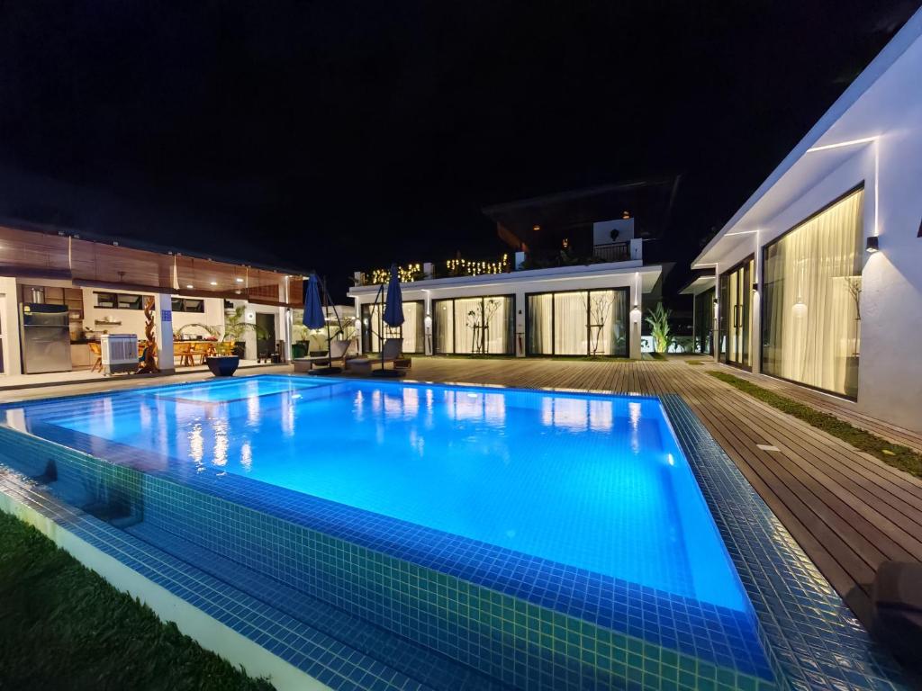 a swimming pool at night in a building at Borneo Bali Villa by Meetstay in Sandakan