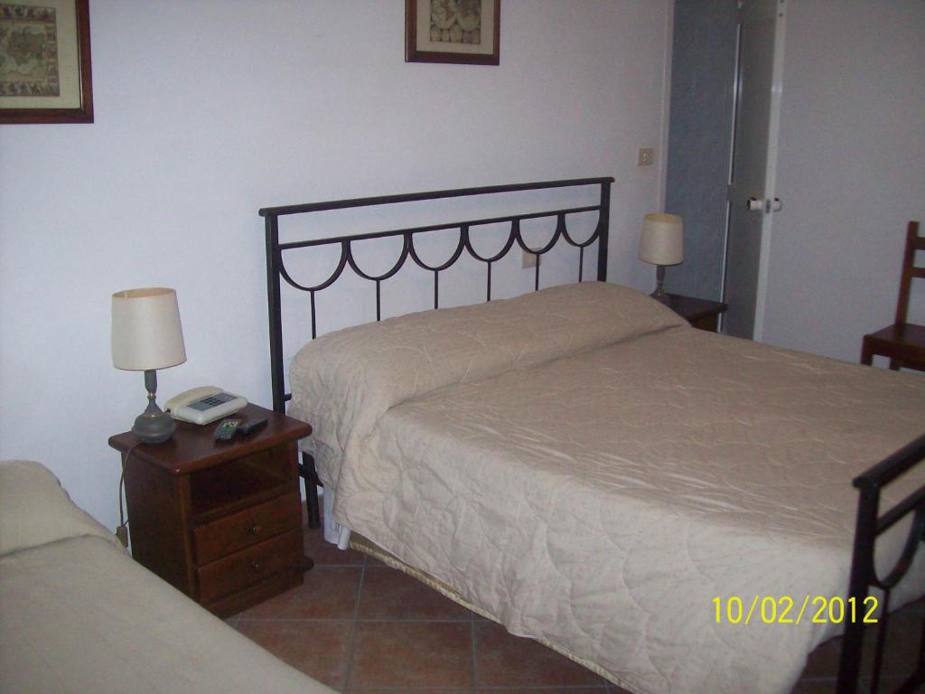 Postel nebo postele na pokoji v ubytování Albergo La Perla