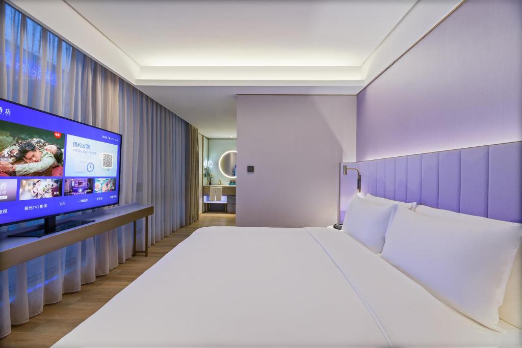 Postelja oz. postelje v sobi nastanitve Shanghai Hongqiao Airport National Exhibition Center Manxin Hotel
