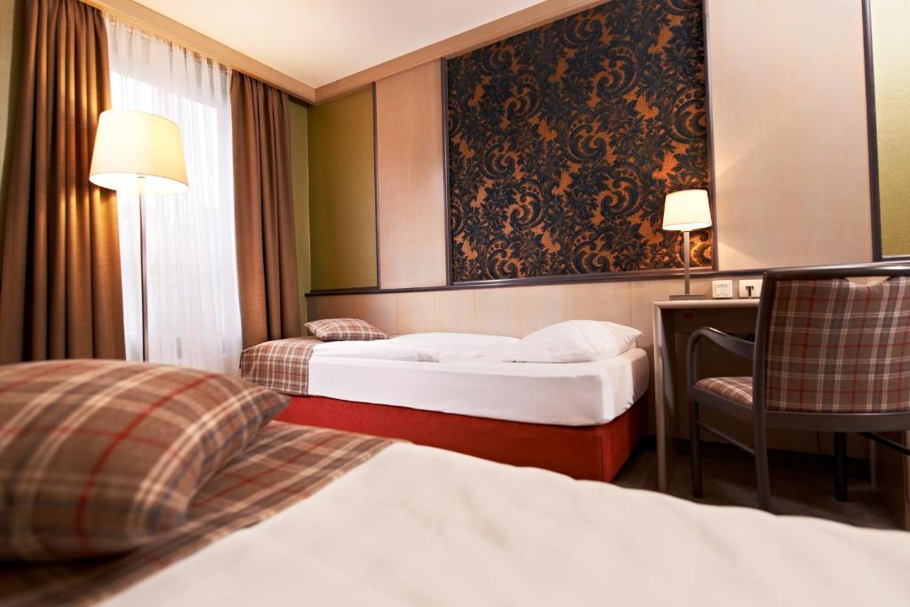 Postel nebo postele na pokoji v ubytování Weinberghotel Edelacker