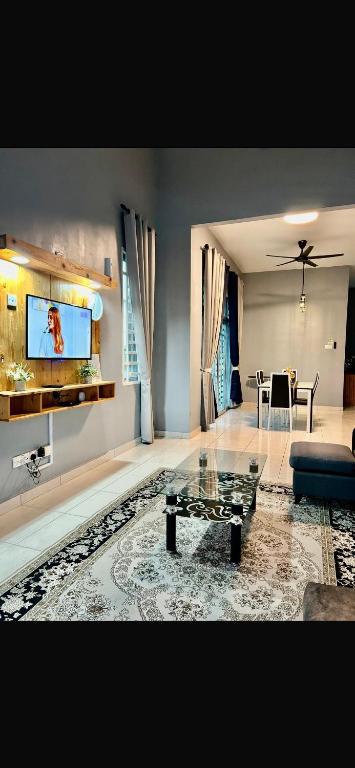 a living room with a couch and a table at Habibie Homestay-Gunung Jerai in Guar Chempedak